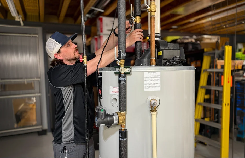 Rozga Plumbing Corp technician installing a water heater in a Southeastern Wisconsin home
